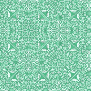Bright green cut paper intricate floral pattern on white 