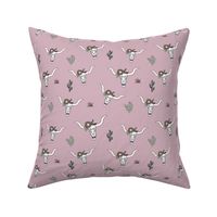 Ranch life with longhorn cows skull boho flowers and cacti western desert theme on rose pink