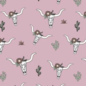 Ranch life with longhorn cows skull boho flowers and cacti western desert theme on rose pink