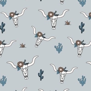 Ranch life with longhorn cows skull boho flowers and cacti western desert theme on blue gray