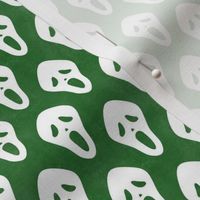 Small Scale White Halloween Scream Face Masks on Green
