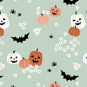 Happy halloween pumpkins bats and spiders with boho blossom vintage daisies orange white on mint