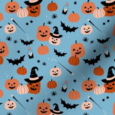 Magic pumpkin patch witches magic wand and creepy animals bats and spiders on blue 