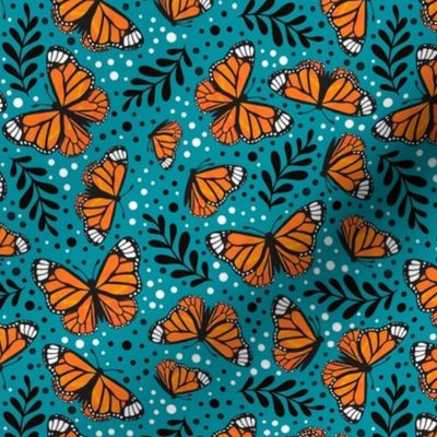 Medium Scale Orange Monarch Butterflies on Lagoon Blue