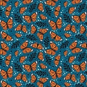 Small Scale Orange Monarch Butterflies on Peacock Blue