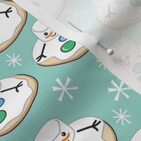 melting snowman cookies on teal