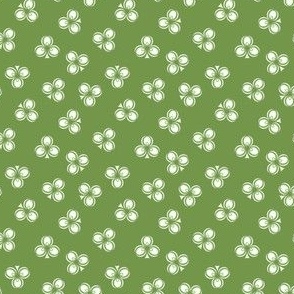 Irish Green and White Shamrocks scattered in an all over pattern on an Irish green background.