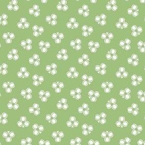 White Irish Shamrock Leaves Scattered on a Contrasting Avocado Green Background