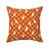 Spooky halloween ghosts and stars on checkerboard adorable kawaii baby nineties trend nursery design orange rust