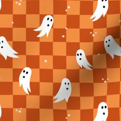 Spooky halloween ghosts and stars on checkerboard adorable kawaii baby nineties trend nursery design orange rust