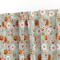 Smiley pumpkin buckets and sunflowers trick or treat fright night halloween kids design with candy corn and lollipops pink blush orange seventies vintage palette on sage green