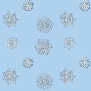 Icy white snowflakes on light blue