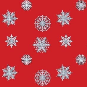 Icy white snowflakes on red