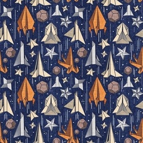 Tiny scale // Reaching for the stars // navy blue background ivory grey brown and orange origami paper asteroids stars and space ships traveling light speed