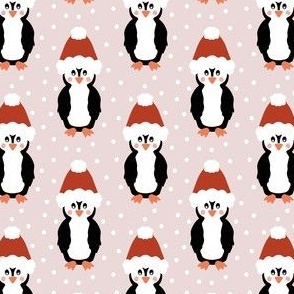 Jolly Christmas penguins in Santa hats on blush pink