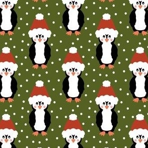 Jolly Christmas penguins in santa hats on green