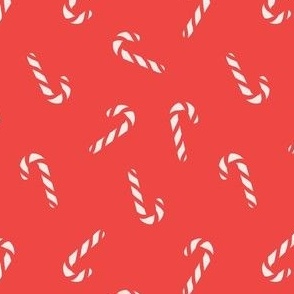 Christmas candy canes on bright red