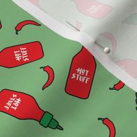(S Scale) Hot Stuff | Hot Sauce Bottle with Peppers Scattered on Green