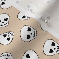 Little day of the dead love skulls halloween kids design on soft beige sand