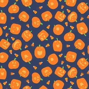 Tossed Laughing Funny Halloween Pumpkins with Light Orange Faces and Candy Corn on Blue Background Non Directional Medium