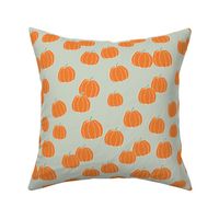 Raw minimalist ditsy pumpkin garden fall design in orange on sage green