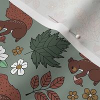 Woodland animals autumn garden red squirrels and leaves acorns and flowers fall kids design green rust red beige on olive