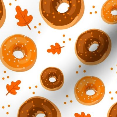 Large Scale Frosted Pumpkin Spice and Maple Frosted Sprinkle Donuts on White