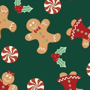 Large Christmas Gingerbread Men and Women surrounded by Holly and Round Peppermint Candy with Green Background
