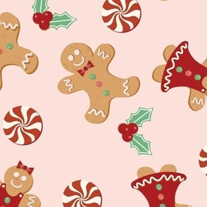 Large Christmas Gingerbread Men and Women surrounded by Holly and Round Peppermint Candy with Pale Pink Background