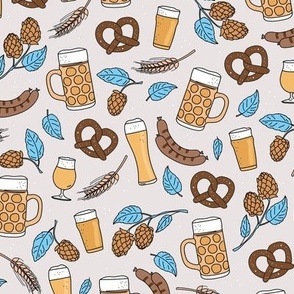 Bavarian blue beer glasses sausages and pretzels traditional german food and drinks oktoberfest theme yellow blue on sand tan
