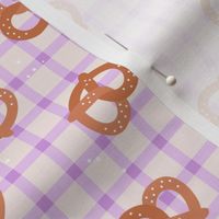 Tossed pretzels on traditional tartan table cloth plaid german food oktoberfest theme lilac blush