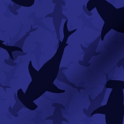 Hammerhead Sharks in Blue Silhouette Circling in Dark Blue Water