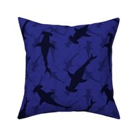 Hammerhead Sharks in Blue Silhouette Circling in Dark Blue Water