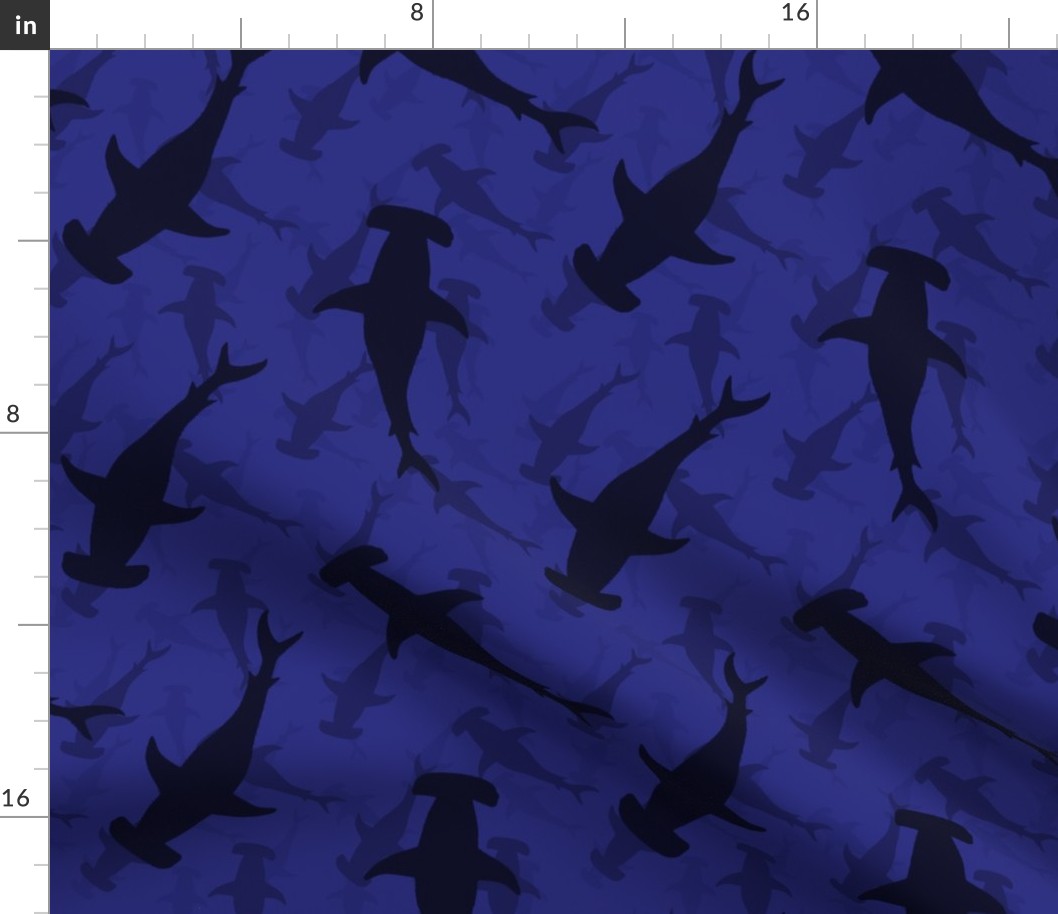 Hammerhead Sharks in Blue Silhouette Circling in Dark Blue Water