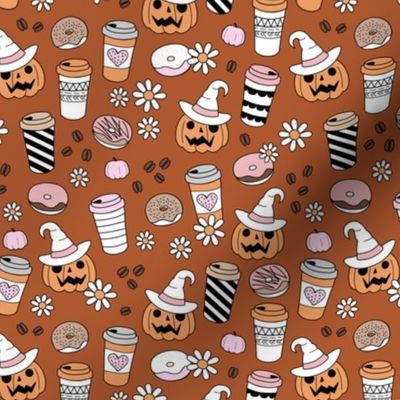 Pumpkin spice and halloween witch fall coffee cups to go boho cutesie vintage drinks and daisies autumn blossom pink orange on sienna rust