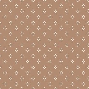 4 cream dots in a diamonds shape on a brown background