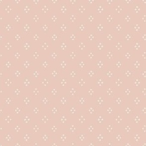 4 cream dots in a diamonds shape on a pink background