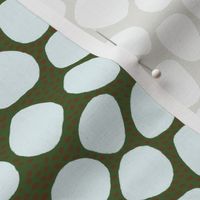 light blue and brown spots and dots on dark green