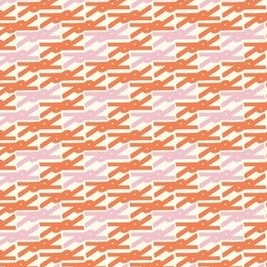 Bright symmetrical geometric scissor shape in orange and pink
