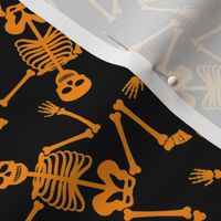 Small Bright Orange Dancing Halloween Skeletons Scattered On Black