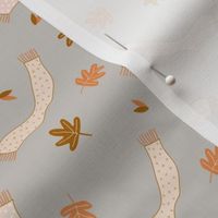 Tiny Autumn Leaves and Scarf in the Wind on gray