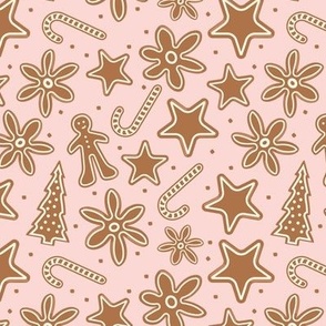 Christmas gingerbread cookie cutouts on light pink