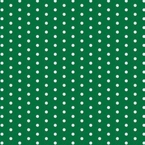 White eighth inch polka dot on deep green