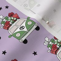 Happy holidays colorful Christmas camper van hippie bus with presents driving home for Christmas vintage starry night green red on lilac purple