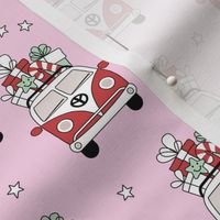 Happy holidays colorful Christmas camper van hippie bus with presents driving home for Christmas vintage starry night ruby red pink