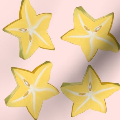 Sliced star fruit on pink background