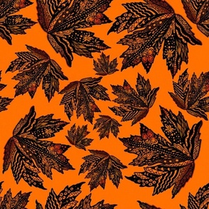 Handdrawn doodled autumn fall maple leaves tossed on orange canvas