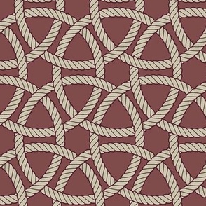 large interlocking rope rings in maroon and cream on greyed red