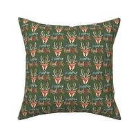 Cute reindeer heads / small/  watercolor sleepy reindeer faces on dark green with the lettering dreaming of Rudolph