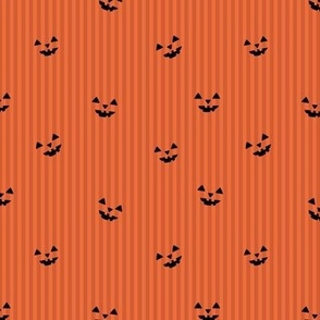 Pumpkin carving spooky eyes on orange stripes minimalist halloween design orange rust